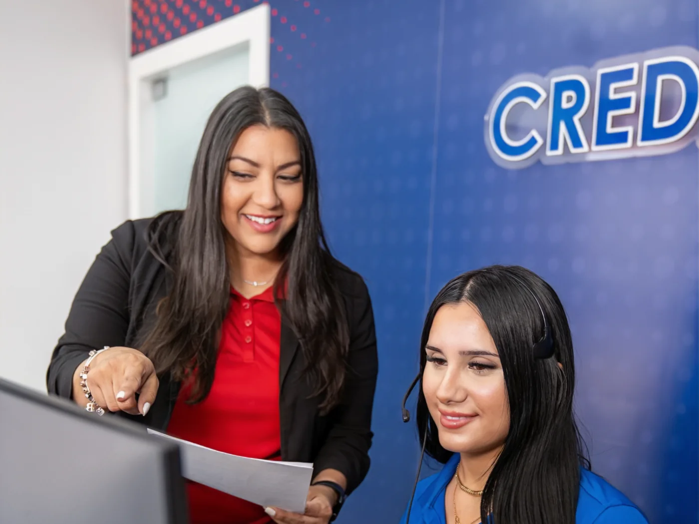 Two A Plus specialists reviewing a dispute together at the computer